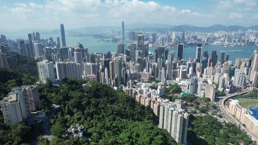 City Aerial in Hong Kong Island 4K Aerial shot of the premium residential area at mid level and the central financial business along the sides of the Victoria Harbour Royalty-Free Stock Footage #1101223619