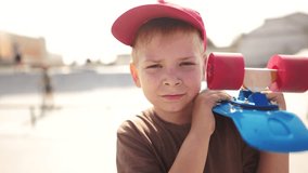 child boy with a skateboard. boy in red cap with a skateboard on the playground portrait. skateboarder child close-up outdoors sun glare. kid lifestyle skateboarder looking at the camera - Powered by Shutterstock - Get 15% off with code: PIKWIZARD15