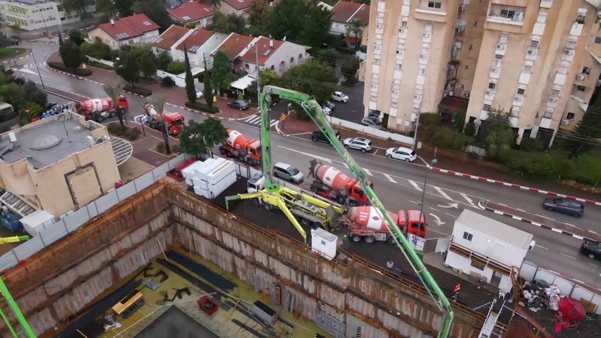 Aerial view of skyscrapers in construction with heavy machines working, Tel Aviv, Israel