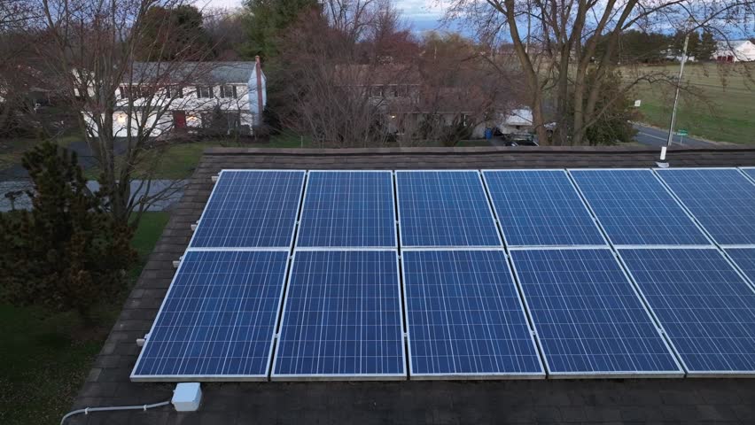 Solar panel array on roof of residential home in America. Aerial truck shot of sustainable energy solution. Royalty-Free Stock Footage #1101232785
