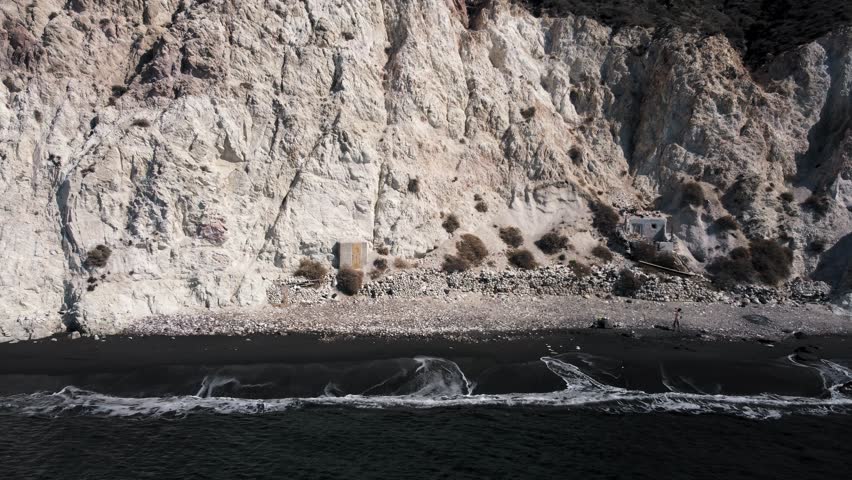 Santorini Island coast line. Travelling in Greece. Pull back aerial view