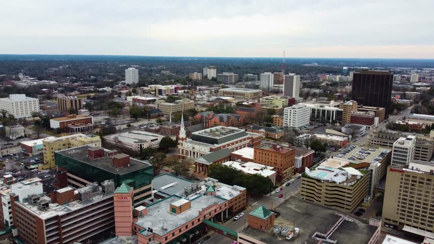 A drone shot of Downtown Columbia, SC. With a church and the state capital visible.
