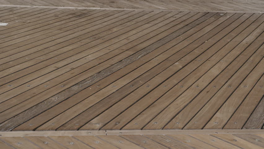 Static close up of woman cycling across boardwalk in Atlantic City New Jersey
