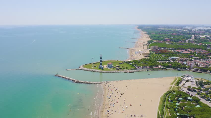 Inscription on video. Italy, Jesolo. Light House Faro di Piave Vecchia. Lido di Jesolo, is the beach area of the city of Jesolo in the province of Venice. Name is burning, Aerial View, Departure of t