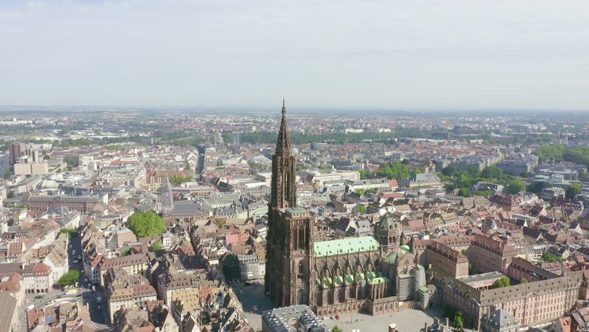 Inscription on video. Strasbourg, France. The historical part of the city, Strasbourg Cathedral. Shimmers in colors purple, Aerial View, Point of interest