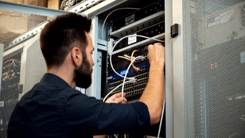 Cable Blockchain Diagnostic Network Engineer In Server Room Mining Farm. It Infrastructure Data Center. It Specialist On Server Racks Data Security Administrator In Technical Department On Server Room Royalty-Free Stock Footage #1101254153