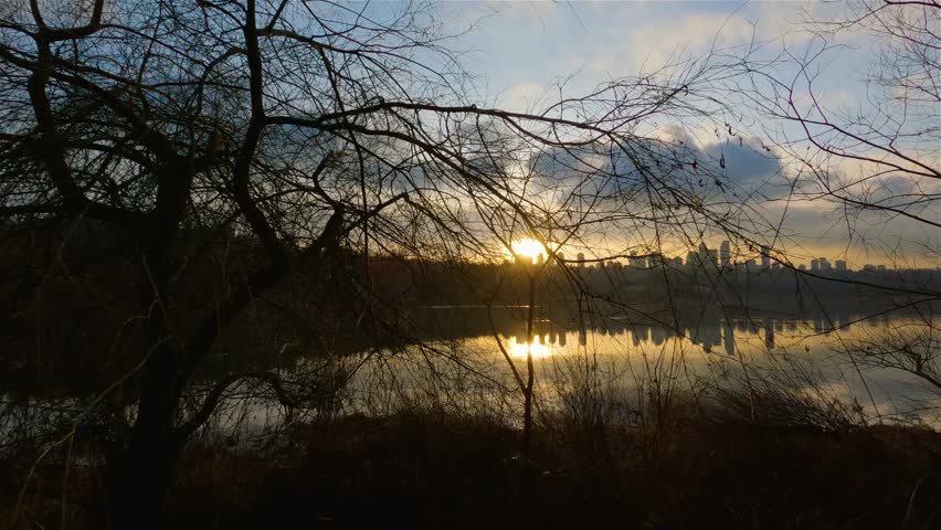Trail by Peaceful Lake in the modern city, Deer Lake Park. Burnaby, Vancouver, BC, Canada. Colorful Winter Sunset Sky. Slow Motion Cinematic Pan.