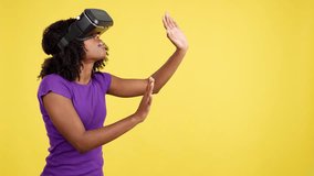 Curious afro woman gesturing while wearing a virtual reality goggles - Powered by Shutterstock - Get 15% off with code: PIKWIZARD15