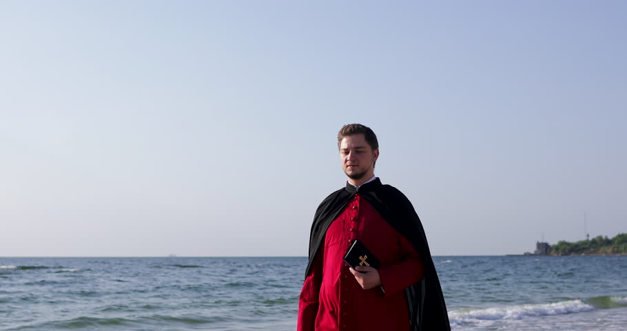 Priest in the mantle hold the Orthodox Bible