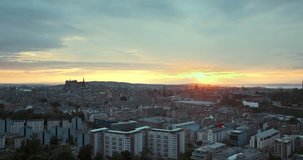 Edinburgh, UK. Aerial view of Edinburgh, Scotland. 4k footage of the city of Edinburgh against the backdrop of the sunset sky. Video with the forward camera motion. Cloudy sunset sky