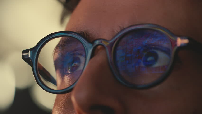 Flash image of planet destruction in the reflection in dark glasses of a man who realizes his impact on the planet. Focus on his fast-moving eyes following the rapidly scrolling images on a screen Royalty-Free Stock Footage #1101265197