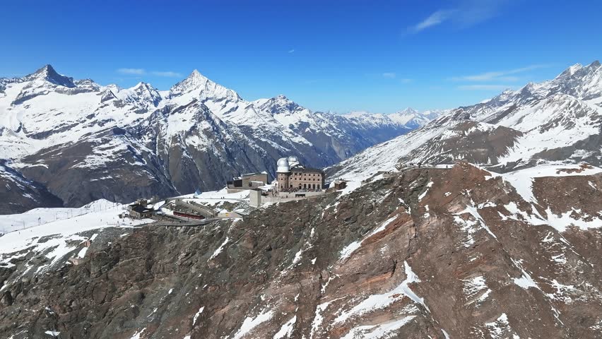 Aerial panorama view of the luxury hotel and the astronomic observatory at the Gornergrat, in the background of the Matterhorn or Cervino mount, Zermatt, Valais, Switzerland, Europe