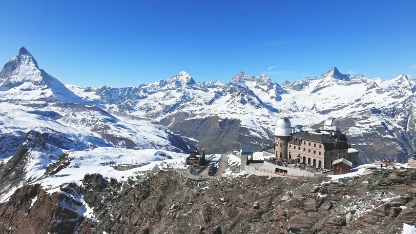 Aerial panorama view of the luxury hotel and the astronomic observatory at the Gornergrat, in the background of the Matterhorn or Cervino mount, Zermatt, Valais, Switzerland, Europe