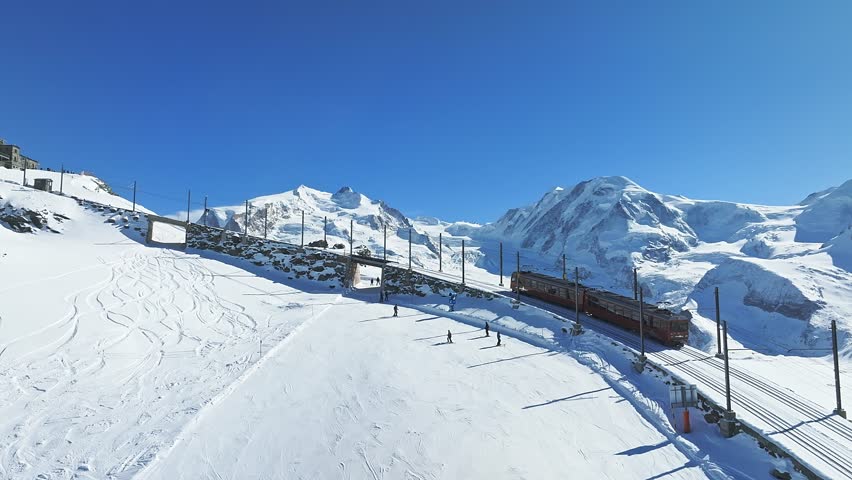 Zermatt, Switzerland -The train of Gonergratbahn running to the Gornergrat station and observatory  in the famous touristic place with clear view to Matterhorn.