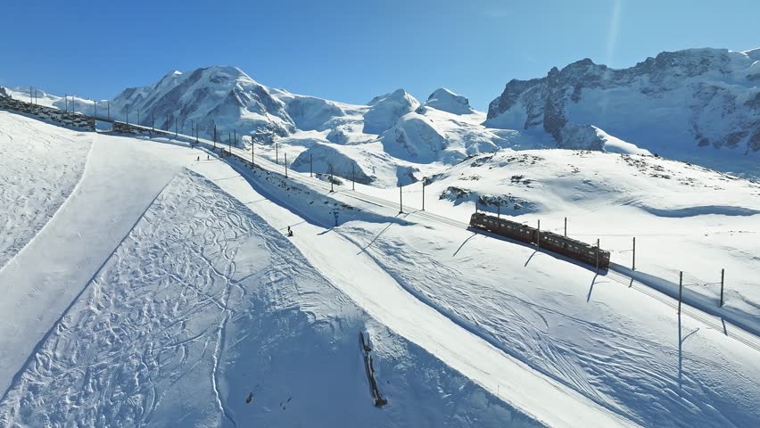Zermatt, Switzerland -The train of Gonergratbahn running to the Gornergrat station and observatory  in the famous touristic place with clear view to Matterhorn.