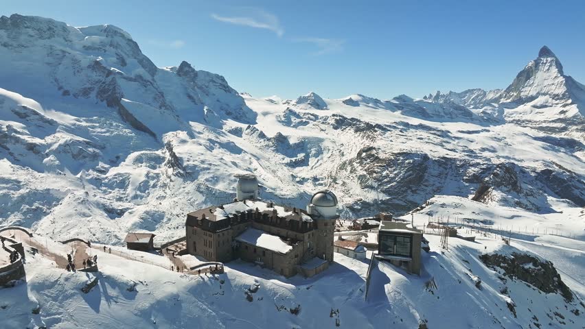 Aerial panorama view of the luxury hotel and the astronomic observatory at the Gornergrat, in the background of the Matterhorn or Cervino mount, Zermatt, Valais, Switzerland, Europe
