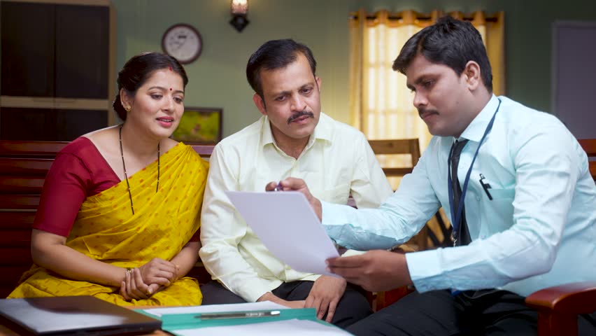 Bank officer advising or explaining about insurance policy papers to couple at home - concept of future planning, consultant and retirement planning. Royalty-Free Stock Footage #1101270753