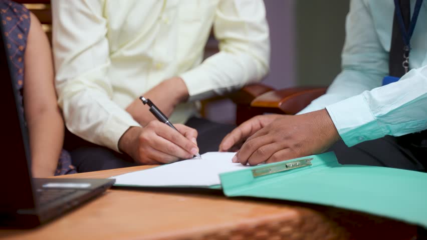 Close up shot of bank officer taking sign from middle aged man for loan of policy insurance documents at home - concept of financial support, selling insurance and doorstep banking Royalty-Free Stock Footage #1101271587