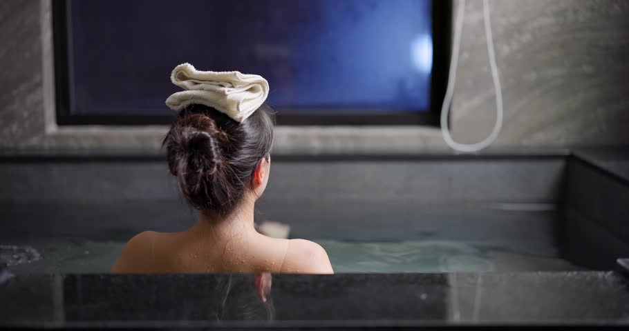 Woman enjoy the hot springs bath at hotel