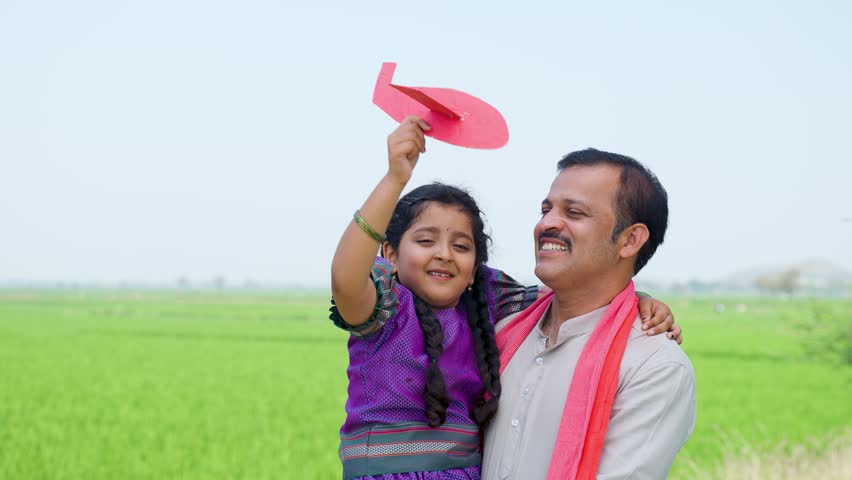 Happy village girl kid playing with airplane toy while father holding or carrying near farmland - concept of relationship, parental caring and healthy lifestyle Royalty-Free Stock Footage #1101275479