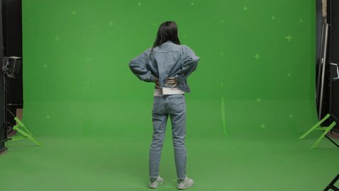 GREEN SCREEN CHROMA KEY Back view full portrait of 30s Asian female looking around, pretending to explore art at an exhibition Adlı Stok Video
