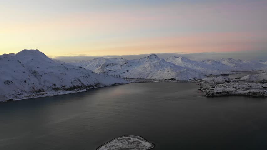 Aerial view of Unalaska Bay in winter with snow at sunset, Unalaska island, Alaska, United States.