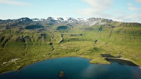 Aerial drone footage of an Icelandic green nature around Kirkjufell mountain in the snaefellsnes peninsula, during summer. High quality 4k footage