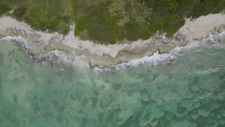 Aerial view of waves rollin got the shoreline along the coast at Montego Bay, Saint James, Jamaica.
