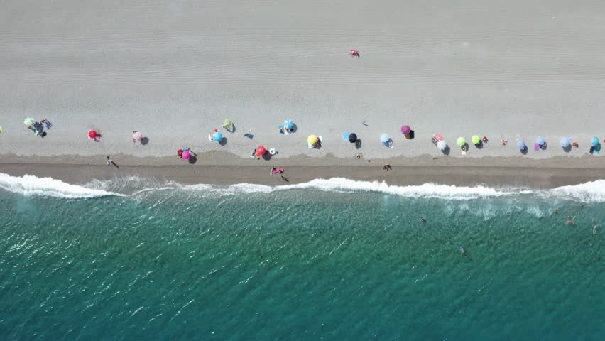 Aerial view of people on the beach in summertime, Sicily, Italy.