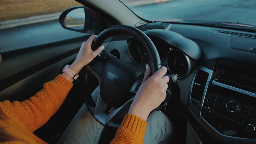Young woman driver using mobile phone while driving car in motion, distracted driving, don't text and drive Royalty-Free Stock Footage #1101289919