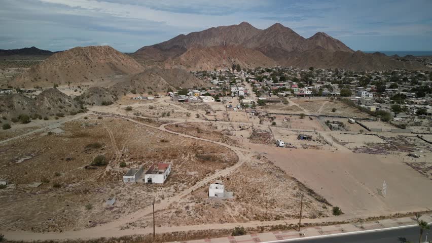 Aerial of neighborhoods in coastal town of San Felipe Baja California with mountain desert backdrop