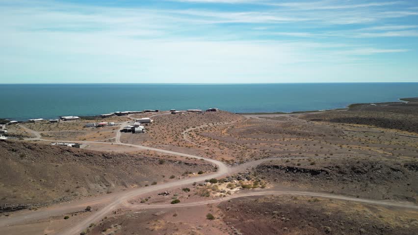 Aerial over remote fishing village in Baja California Mexico on Sea of Cortez in red desert landscape