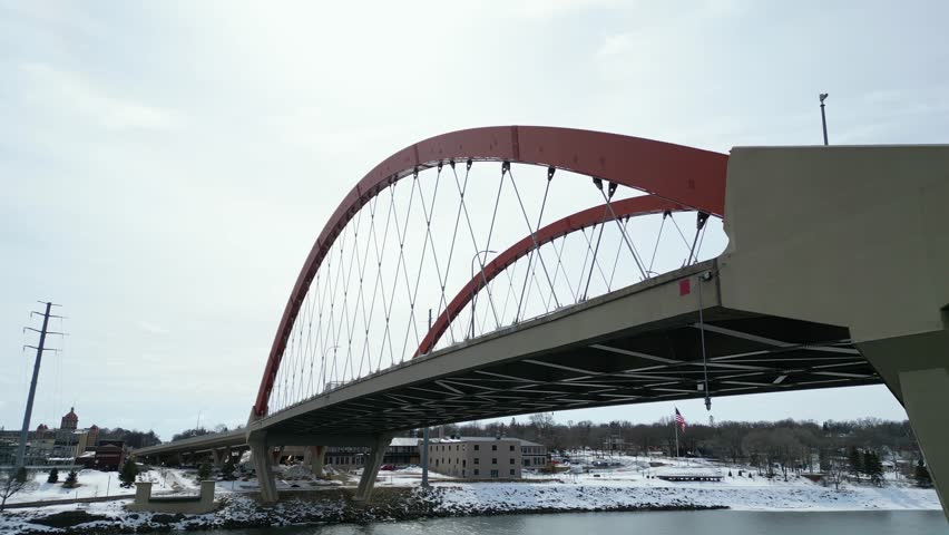 Highway Tied-Arch Bridge over the Mississippi River in the Minnesota Winter with Snow and Cars on the Road