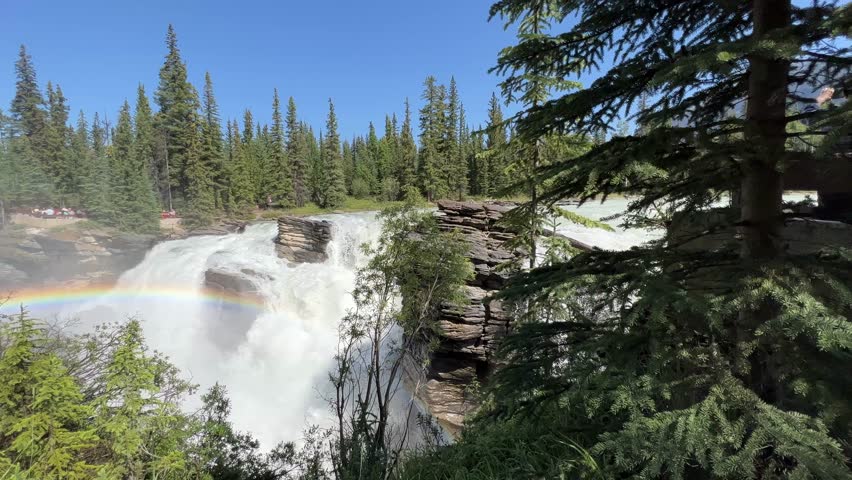 Majestic Athabasca Falls cascading down the rocky cliffs of Jasper National Park, Alberta, Canada. Beautiful view of Athabasca Falls and the powerful waters rushing through its narrow gorge