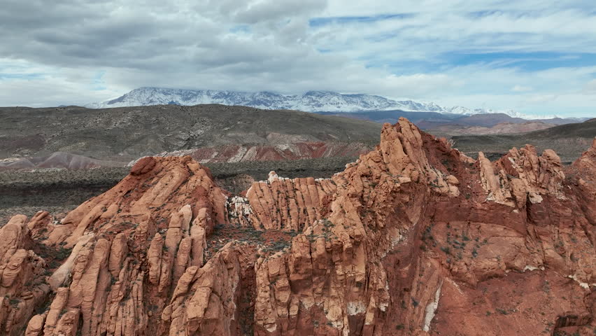 Aerial desert red rock ridge Virgin River gorge Utah. Southwestern desert Utah near St George. Red stone and black volcanic mountain landscape. Geological landscape wind, weather erosion.