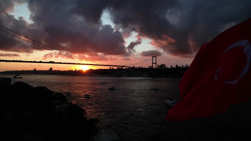 Turkish Flag in the Sunset Time Drone Video, 15 July Martyrs Bridge Beylerbeyi, Uskudar Istanbul, Turkiye  Royalty-Free Stock Footage #1101302563