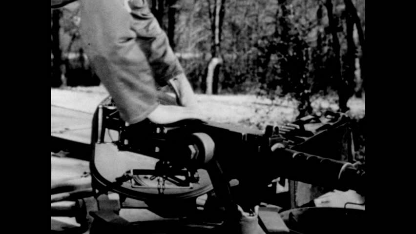 U.S. soldier unloads a machine-gun during Battle of the Bulge, Ardennes, Belgium, Luxembourg circa December, 1944-January, 1945