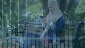 Animation of financial data processing over biracial woman in hijab using smartphone in park. Global connections, business, finances, computing and data processing concept digitally generated video. - Powered by Shutterstock - Get 15% off with code: PIKWIZARD15