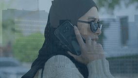 Animation of financial data processing over biracial woman in hijab using smartphone in city. Global connections, business, finances, computing and data processing concept digitally generated video. - Powered by Shutterstock - Get 15% off with code: PIKWIZARD15