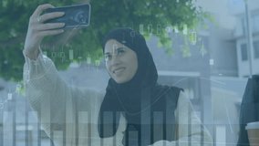 Animation of financial data processing over biracial woman in hijab using smartphone in city. Global connections, business, finances, computing and data processing concept digitally generated video.