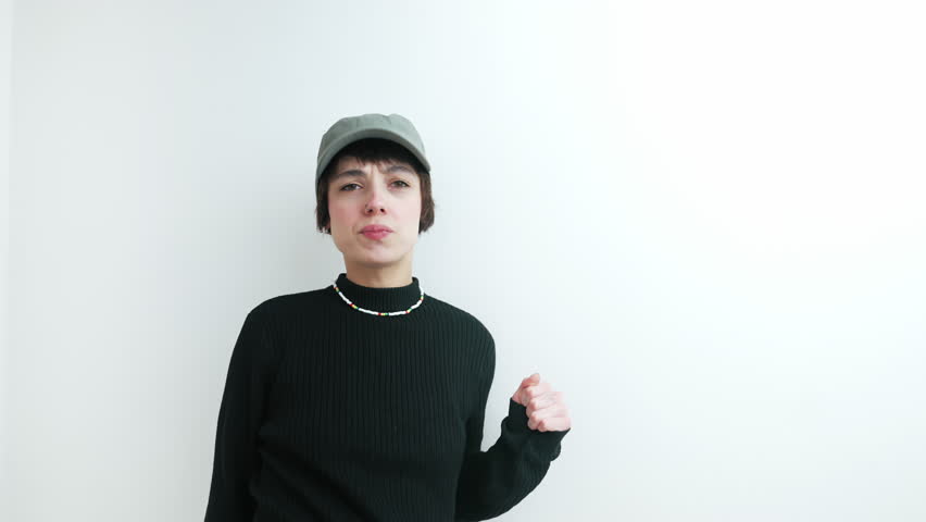 Funky young adult men z woman looking at camera and doing a funny dance over white background. Bored and creative youth. High quality 4k footage