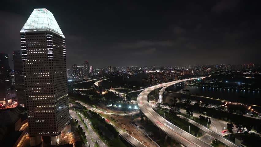 4K wide angle traffic time lapse video from above with rush hour traffic on Benjamin Sheares Bridge landmark during the night. Transportation industry in Singapore.