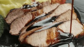 Delicious gravy poured into slices of cut appetizing steak lying next to mashed potatoes - Powered by Shutterstock - Get 15% off with code: PIKWIZARD15