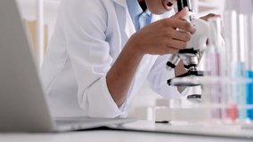 close-up students notice the exchange of chemical experiments using microscope equipment and tube, Science education in laboratory lab for elementary diversity students in white coat in the classroom  - Powered by Shutterstock - Get 15% off with code: PIKWIZARD15