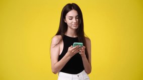 4k video of one girl sending messages on yellow background.