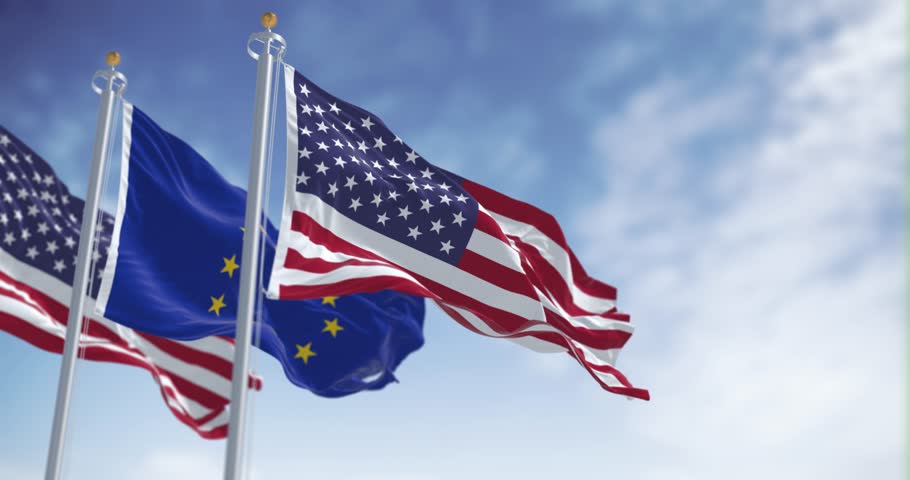 The flags of the United States of America and the European Union waving in the wind on a clear day. Seamless 3d render animation. Selective focus. Slow motion loop. International politics, alliance