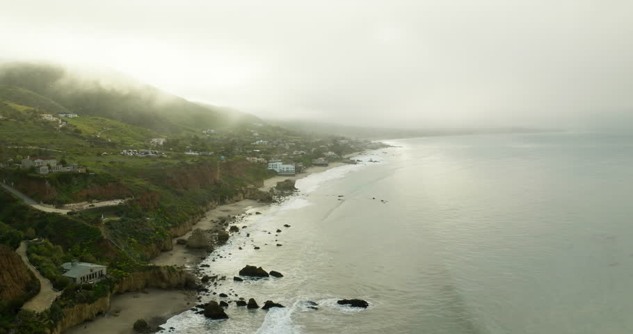 Drone flyover waves crashing on rocky beach, The El matador beach in Malibu, California. Deserted Wild El Matador Beach Malibu California Aerial Ocean View - Waves with Rocks.  Scenic View Of Cliffs. 