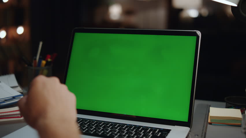 Unrecognizable guy watching mockup laptop at home back view. Closeup anonymous man reading information on green screen computer. Unknown freelancer using chroma key device. Technologies concept Royalty-Free Stock Footage #1101336241