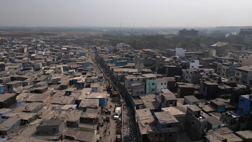 Aerial jib shot showing slums in the Govandi neighbourhood in the the suburbs of eastern Mumbai, Maharashtra, India. Royalty-Free Stock Footage #1101338293