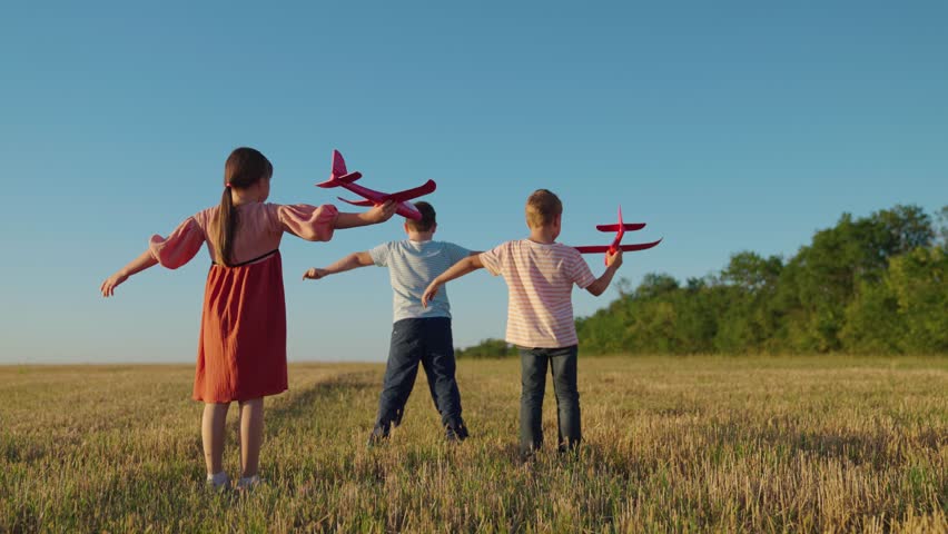 Kids fly, running. Children boy, girl play in park, Friends run together raising their hands, dream is to fly to travel.Creative imagination of children, concept of active play in nature. Happy family Royalty-Free Stock Footage #1101340137